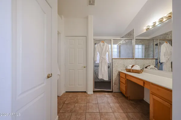 a bathroom with a double vanity sink mirror and shower