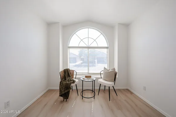 a workspace with wooden floor and a window