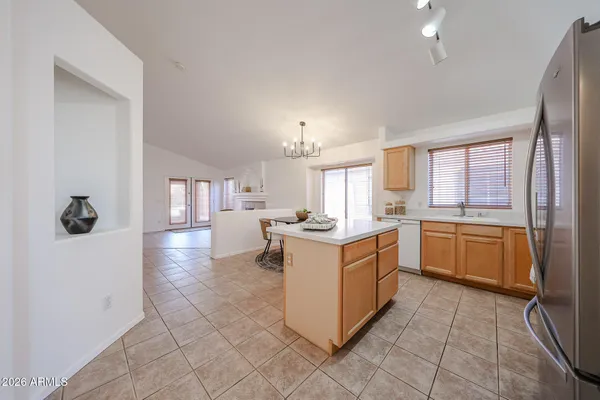 a kitchen with stainless steel appliances a table chairs and a refrigerator