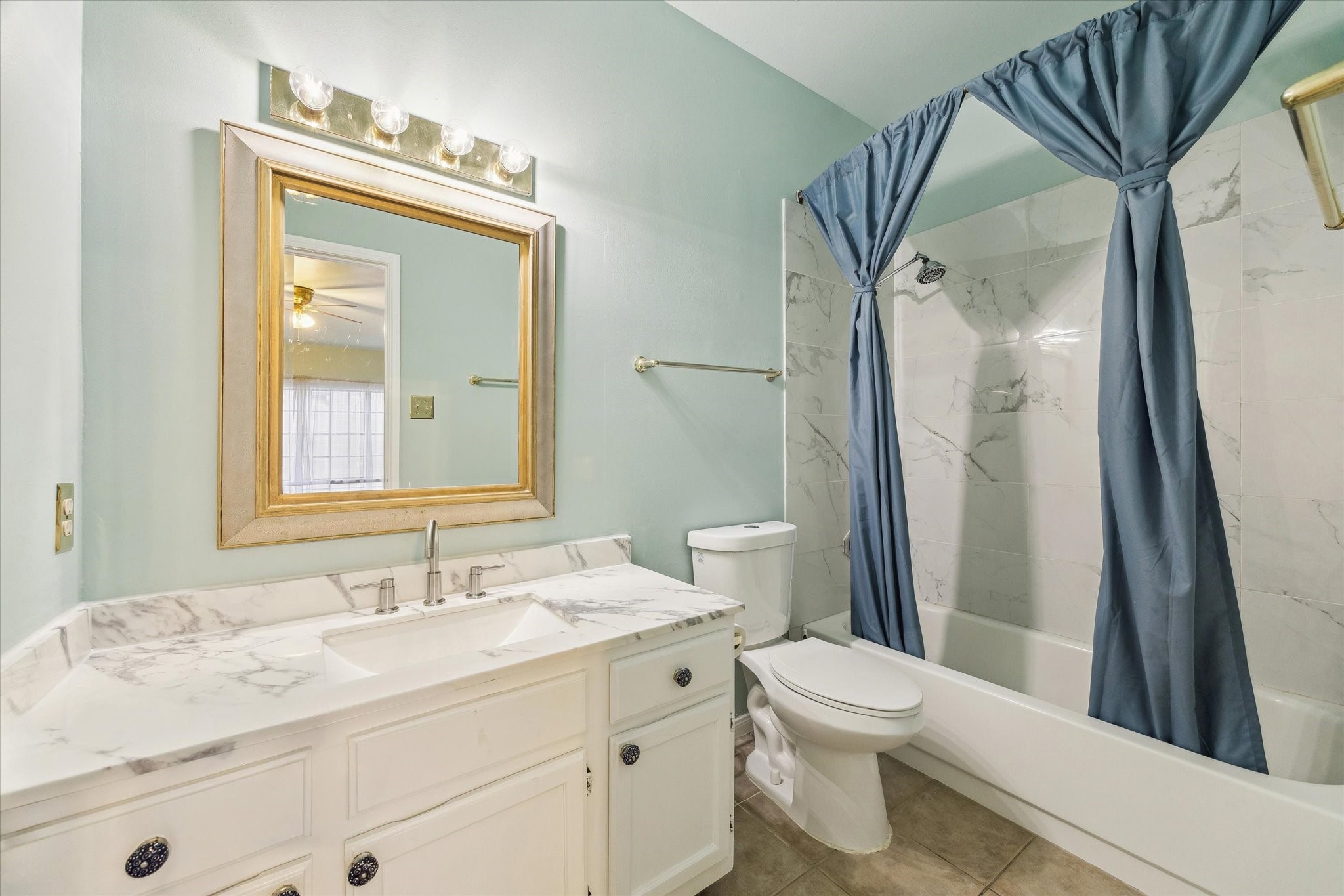 7326 Regency Square Court, Unit 7326 Houston, TX 77036 - Photo 11 of 17 a bathroom with a granite countertop sink toilet and shower