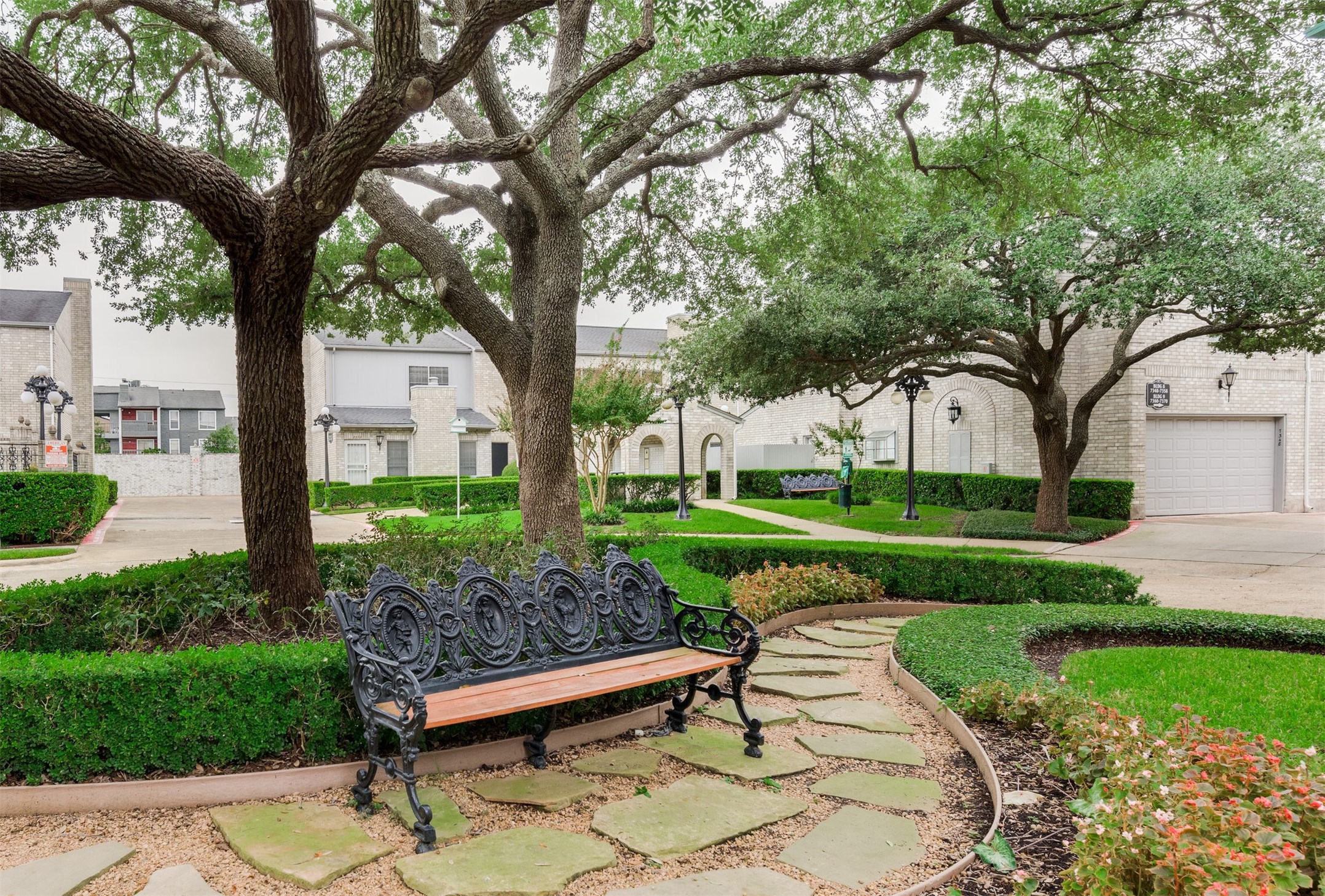 7326 Regency Square Court, Unit 7326 Houston, TX 77036 - Photo 15 of 17 a view of a bench in a garden