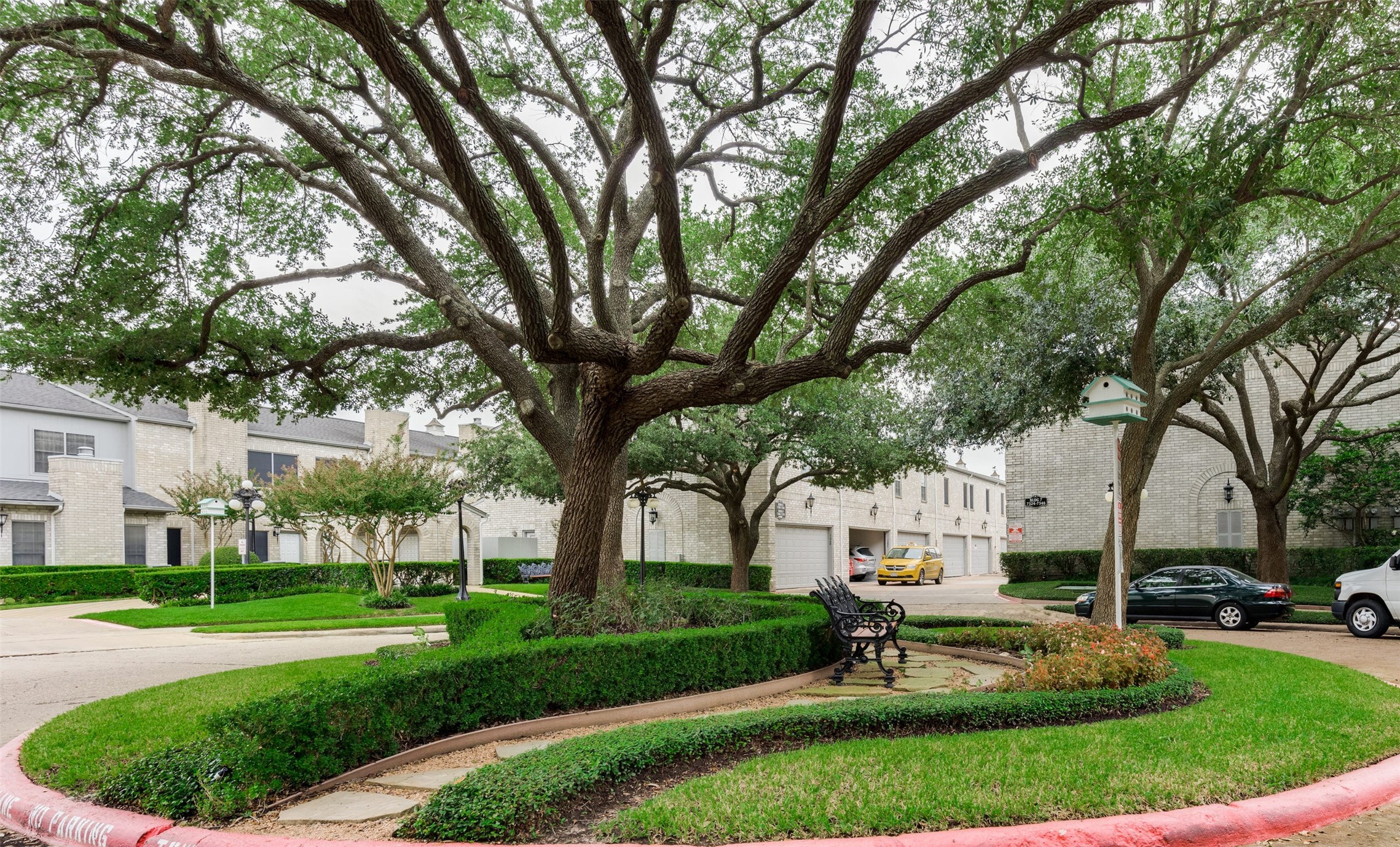 7326 Regency Square Court, Unit 7326 Houston, TX 77036 - Photo 16 of 17 a view of a white house in a big yard with palm trees