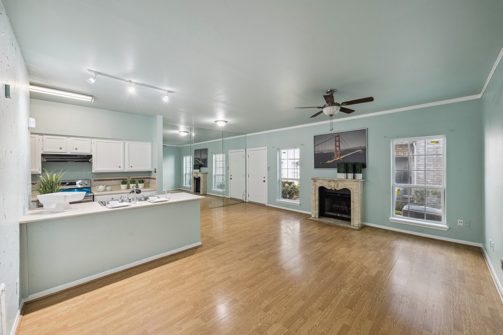 7326 Regency Square Court, Unit 7326 Houston, TX 77036 - Photo 3 of 17 a view of a kitchen with furniture a ceiling fan and wooden floor