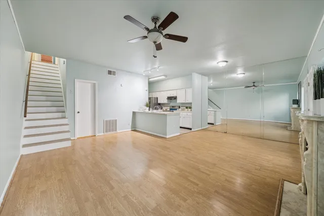 a view of a kitchen with a sink dishwasher a refrigerator with wooden cabinets