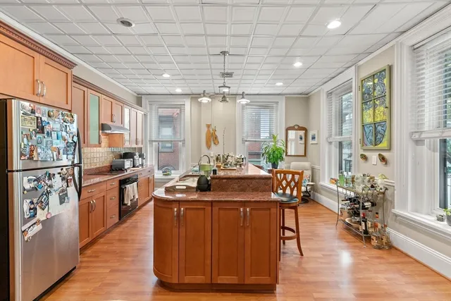 a kitchen with stainless steel appliances granite countertop a stove and a refrigerator