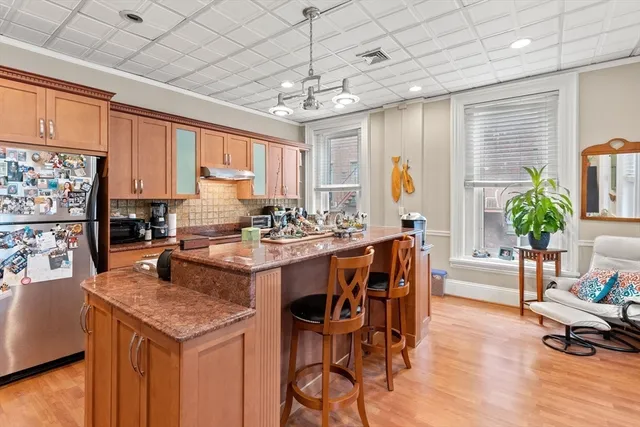a kitchen with a table chairs stove and refrigerator