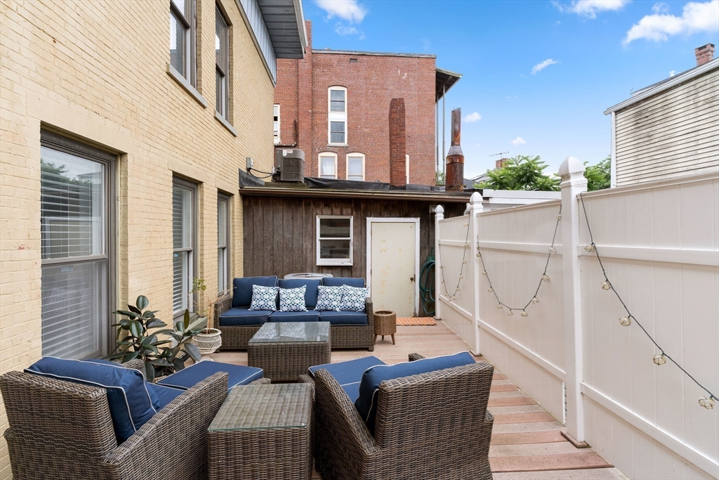 100-102 Main Street Gloucester, MA 01930 - Photo 16 of 40 a living room with furniture and a floor to ceiling window