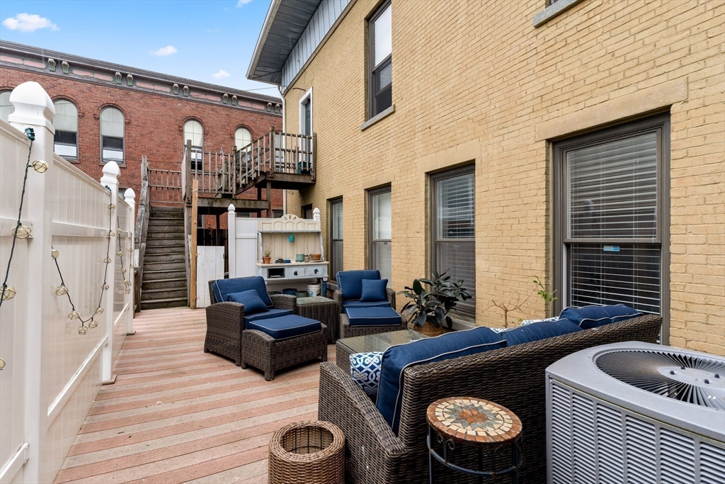 100-102 Main Street Gloucester, MA 01930 - Photo 17 of 40 a living room with furniture and a wooden floor