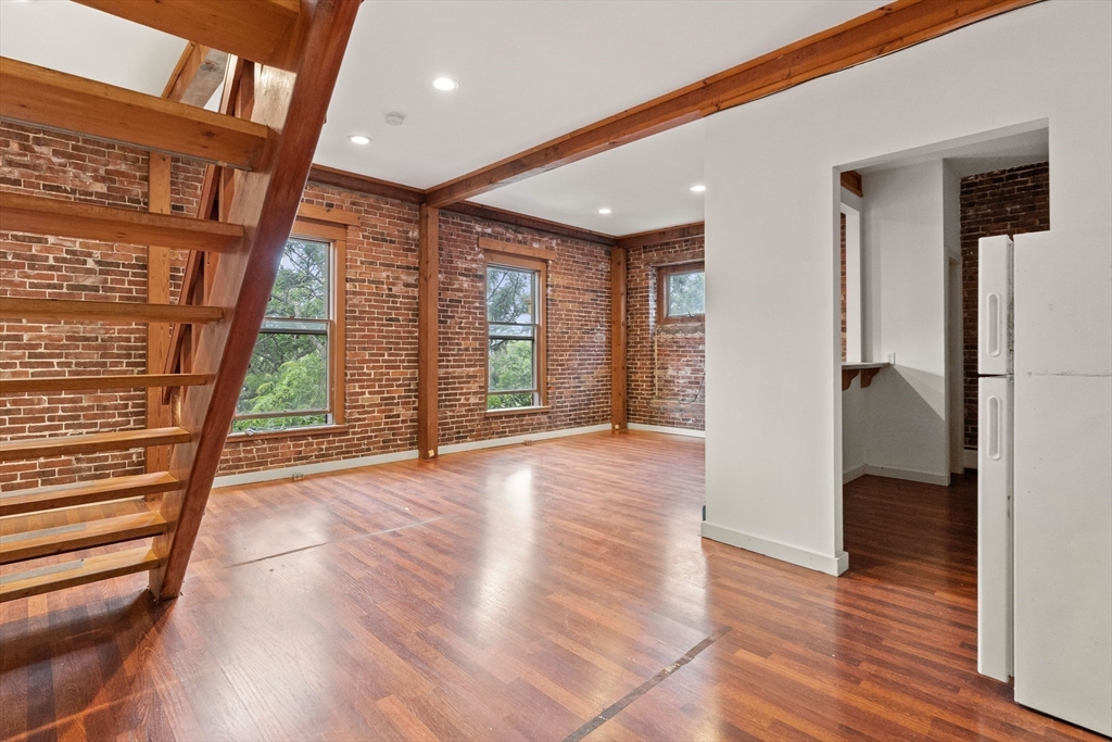 100-102 Main Street Gloucester, MA 01930 - Photo 19 of 40 an empty room with wooden floor and windows
