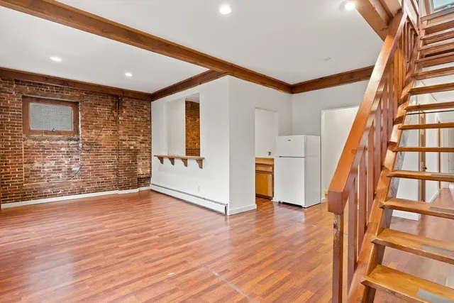 a view of an entryway with wooden floor
