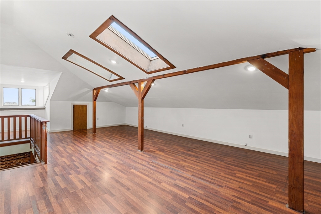 100-102 Main Street Gloucester, MA 01930 - Photo 24 of 40 a view of an empty room with wooden floor and stairs