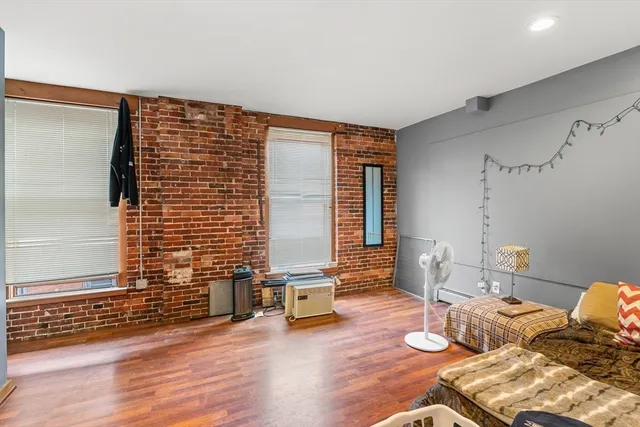a bedroom with furniture and wooden floor