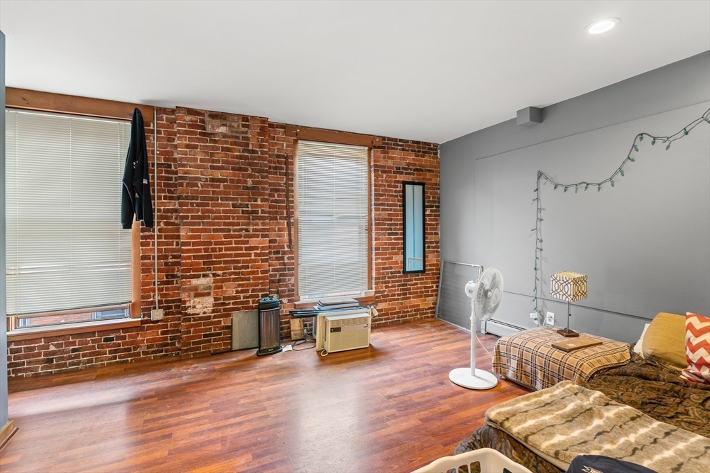 100-102 Main Street Gloucester, MA 01930 - Photo 26 of 40 a living room with furniture and wooden floor