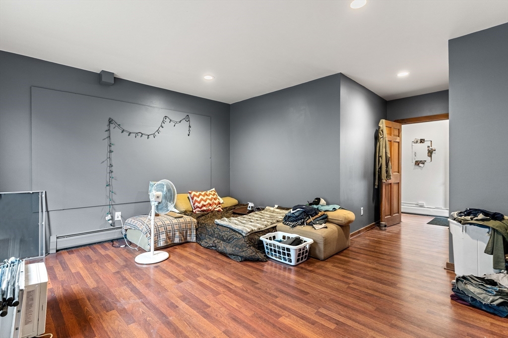 100-102 Main Street Gloucester, MA 01930 - Photo 27 of 40 a bedroom with furniture and wooden floor