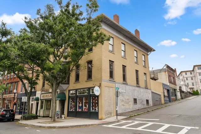 a large building with a tree in front
