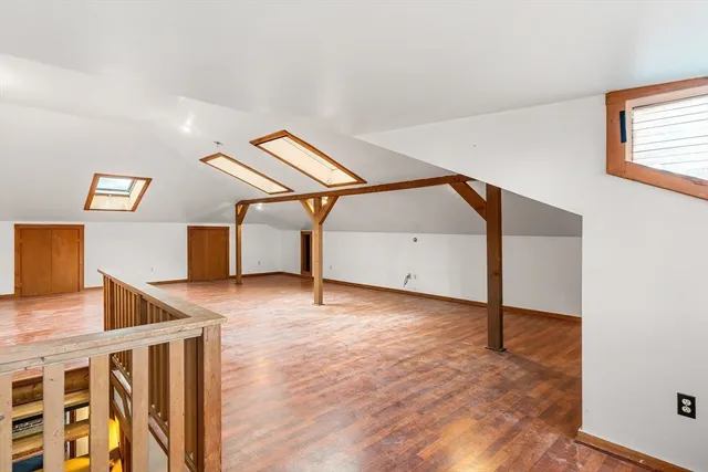 a kitchen with white cabinets and appliances