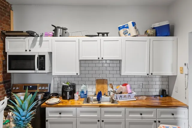 a kitchen with blue cabinets and a stove