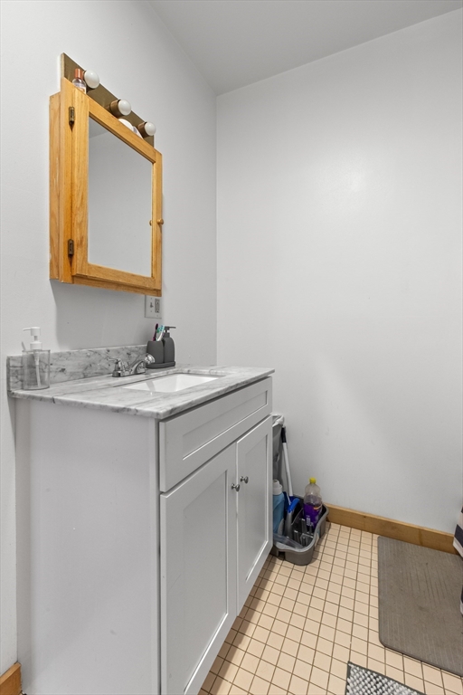 100-102 Main Street Gloucester, MA 01930 - Photo 35 of 40 a bathroom with a sink and a mirror