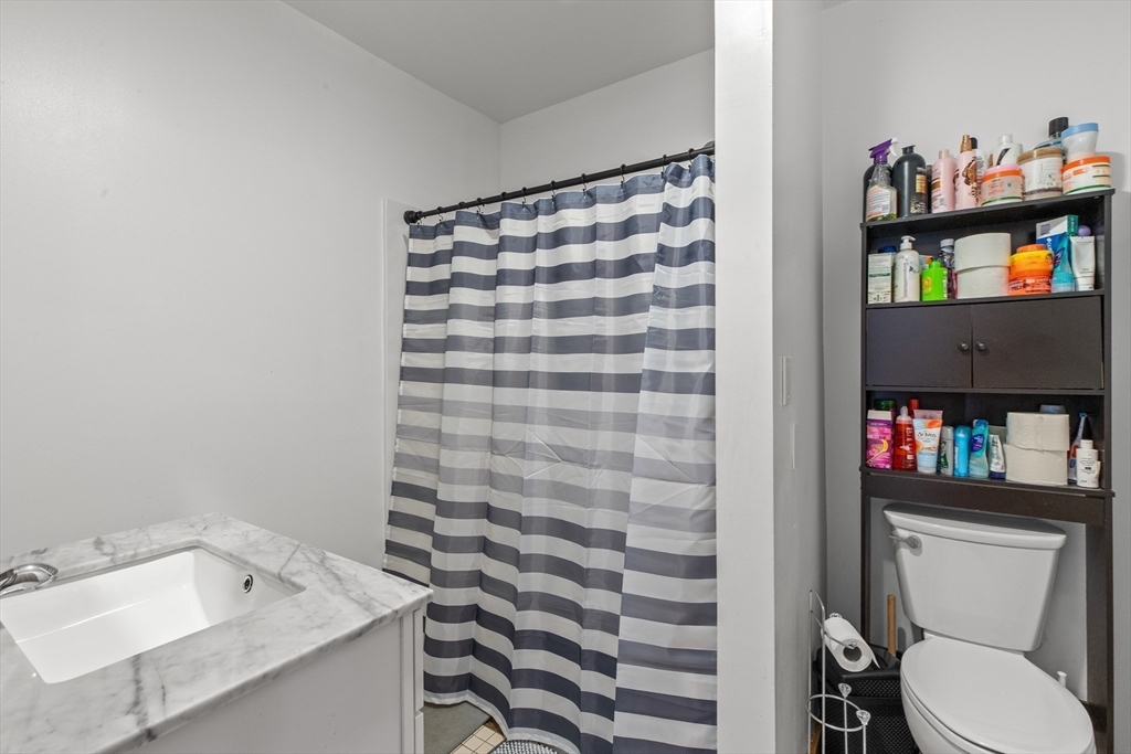 100-102 Main Street Gloucester, MA 01930 - Photo 36 of 40 a bathroom with a sink toilet and a shower