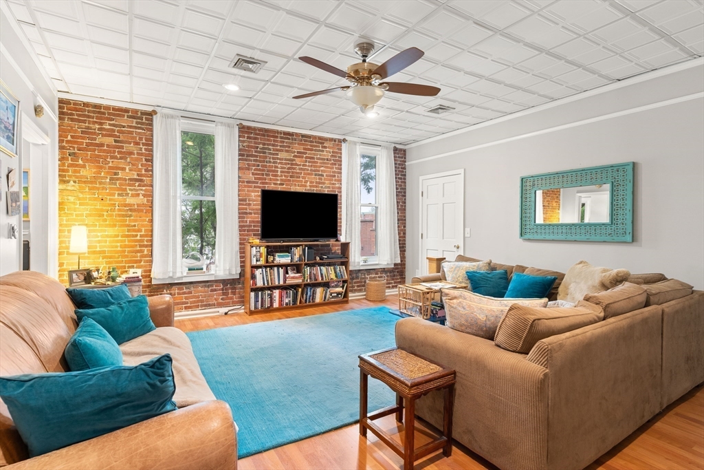100-102 Main Street Gloucester, MA 01930 - Photo 9 of 40 a living room with furniture and a flat screen tv