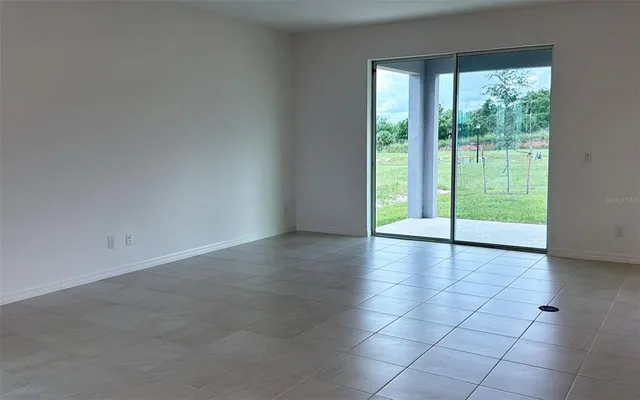 a view of an empty room with glass door