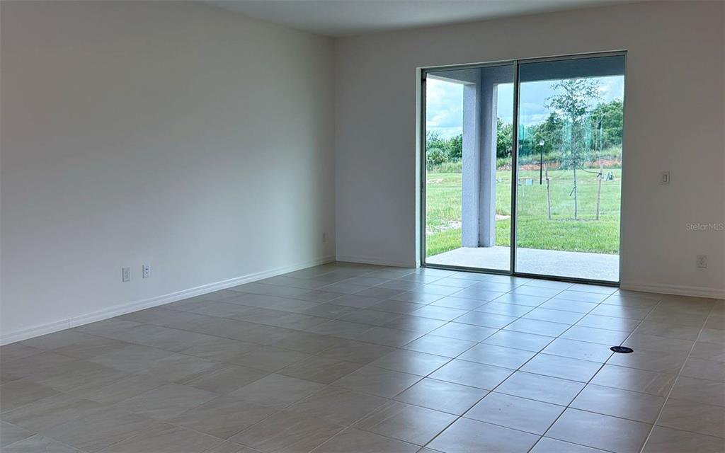 6867 Spanish Imperial Street Howey-in-the-Hills, FL 34737 - Photo 11 of 20 a view of an empty room with glass door