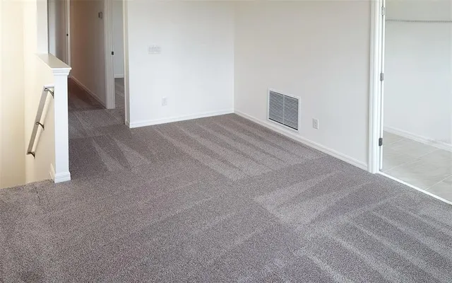 a view of a livingroom with an empty space and a fireplace