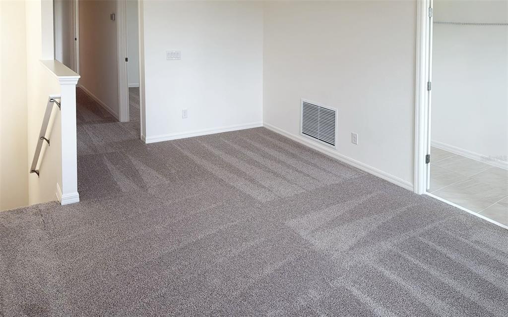 6867 Spanish Imperial Street Howey-in-the-Hills, FL 34737 - Photo 12 of 20 a view of a livingroom with an empty space and a fireplace