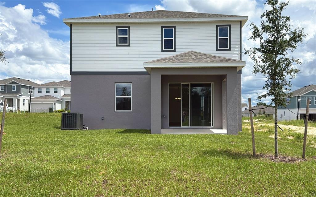 6867 Spanish Imperial Street Howey-in-the-Hills, FL 34737 - Photo 16 of 20 a view of front of a house with a yard
