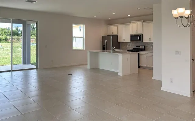 a kitchen with stainless steel appliances a refrigerator sink and microwave