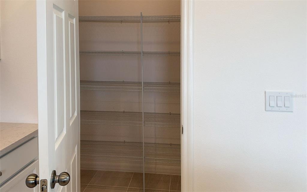 6867 Spanish Imperial Street Howey-in-the-Hills, FL 34737 - Photo 9 of 20 a bathroom with a glass shower door