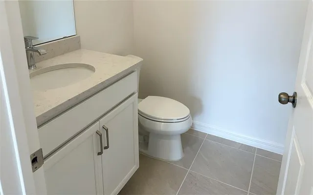 a white toilet sitting next to a shower