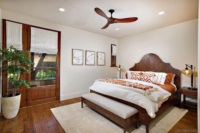 a bedroom with a large bed and a potted plant