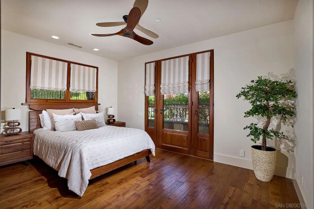 a bedroom with a large bed and a potted plant