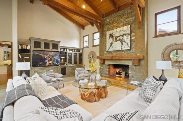 a living room with furniture a fireplace and a table