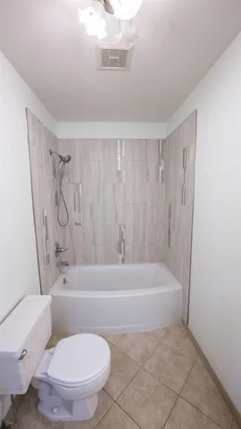 a bathroom with a toilet and a bathtub