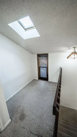 a view of an empty room with stairs