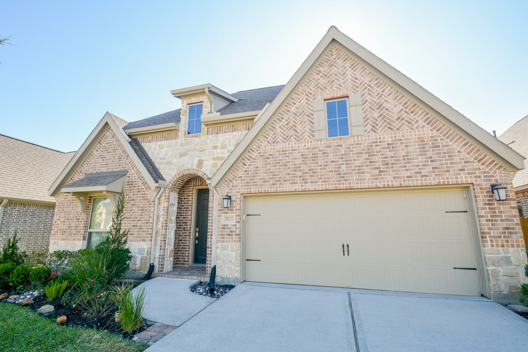 a front view of a house with garage