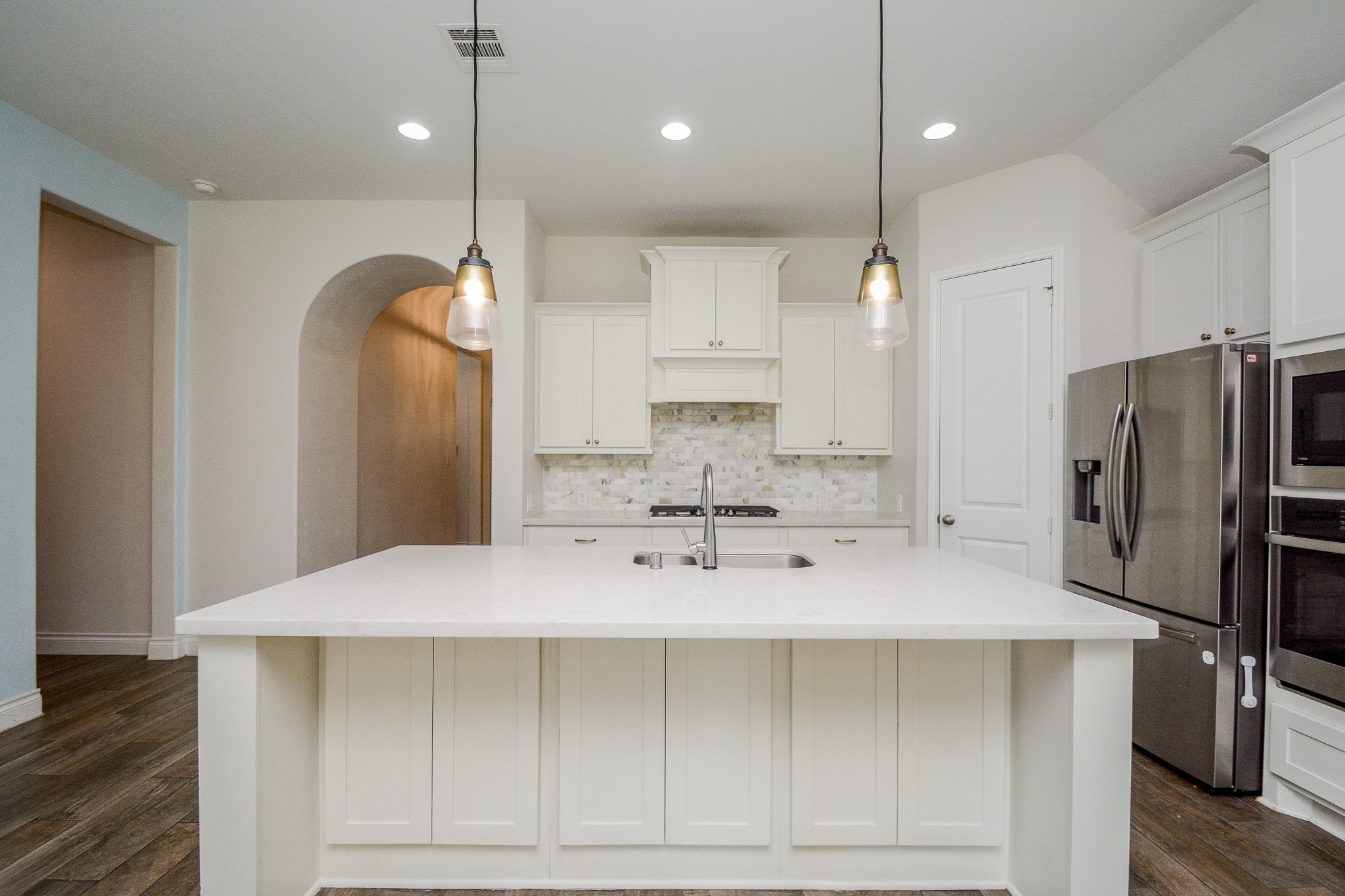28127 Knight Peak Drive Spring, TX 77386 - Photo 12 of 42 a kitchen with stainless steel appliances a refrigerator sink and cabinets
