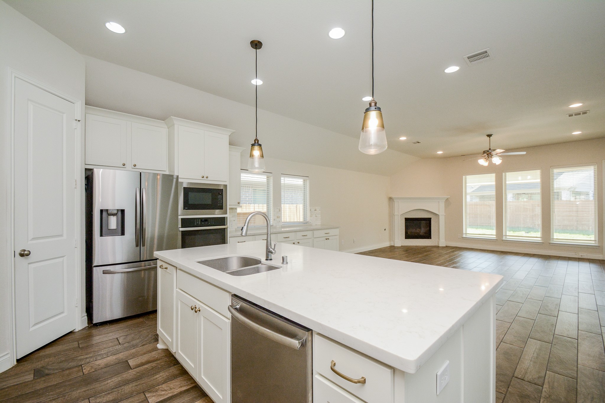 28127 Knight Peak Drive Spring, TX 77386 - Photo 13 of 42 a kitchen with stainless steel appliances kitchen island a sink a stove and a refrigerator