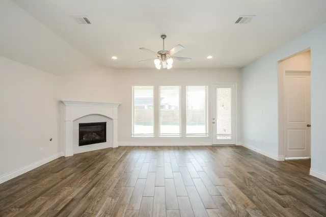 a kitchen with a sink chandelier and wooden floor