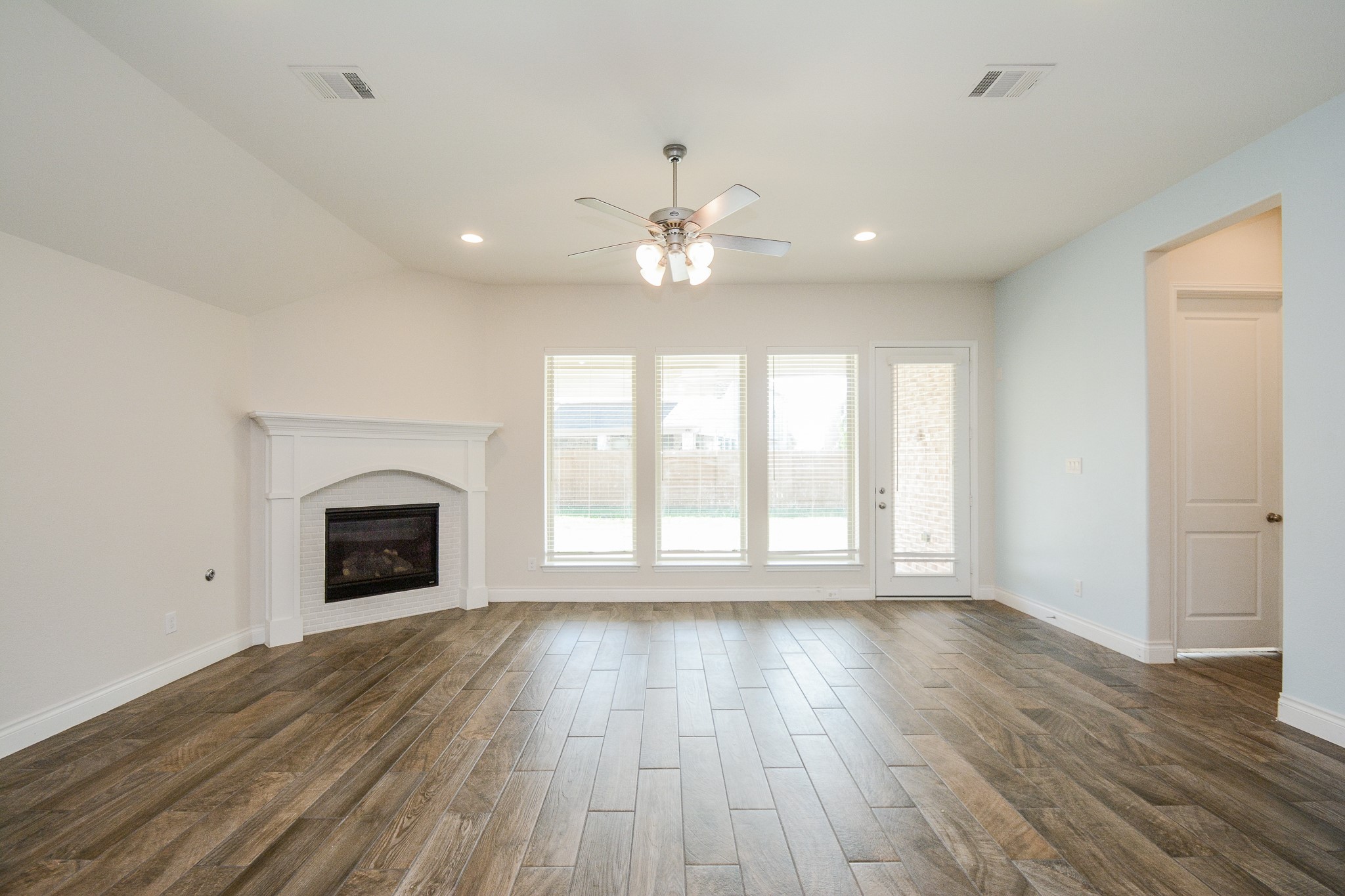 28127 Knight Peak Drive Spring, TX 77386 - Photo 14 of 42 a view of an empty room with a fireplace and a window
