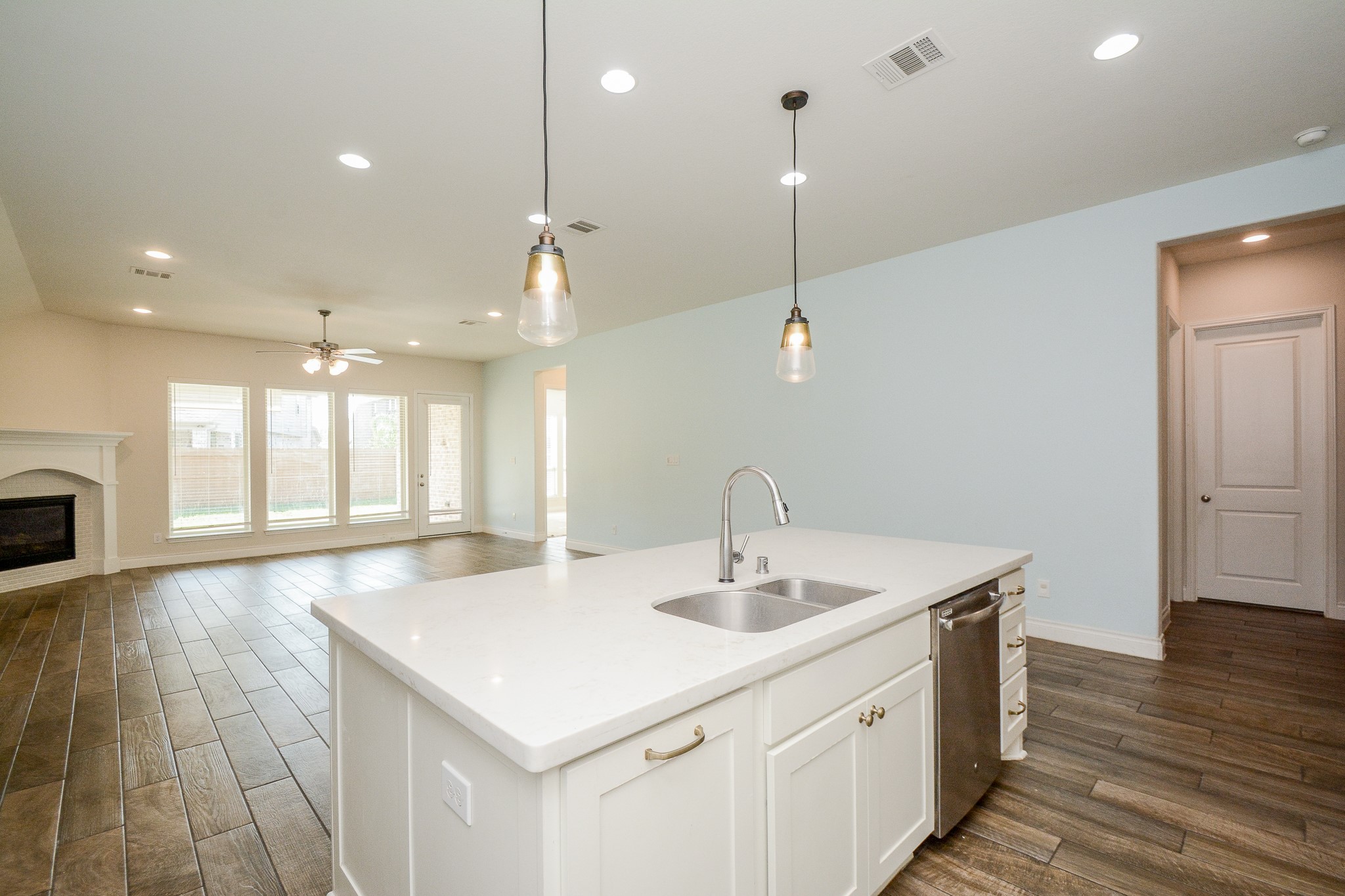 28127 Knight Peak Drive Spring, TX 77386 - Photo 15 of 42 a kitchen with a sink chandelier and wooden floor