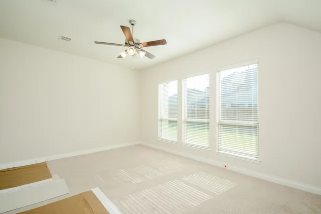 a view of a room with a ceiling fan