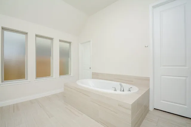 a white bath tub sitting in a bathroom