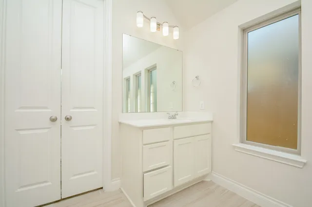 a bathroom with a glass shower door