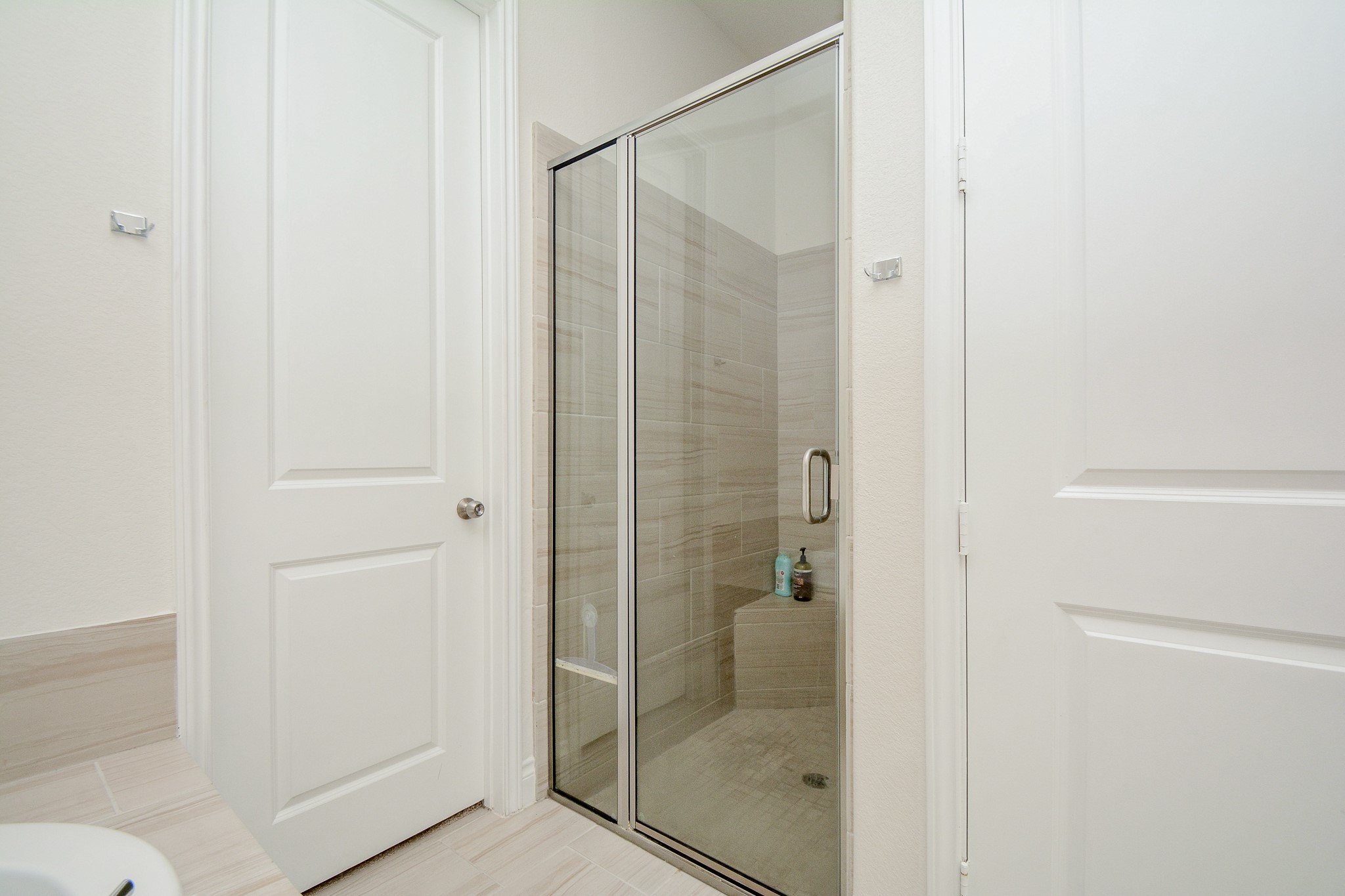 28127 Knight Peak Drive Spring, TX 77386 - Photo 26 of 42 a bathroom with a glass shower door