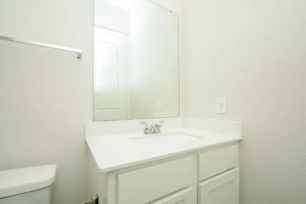a white toilet and tub sitting next to a bathroom sink