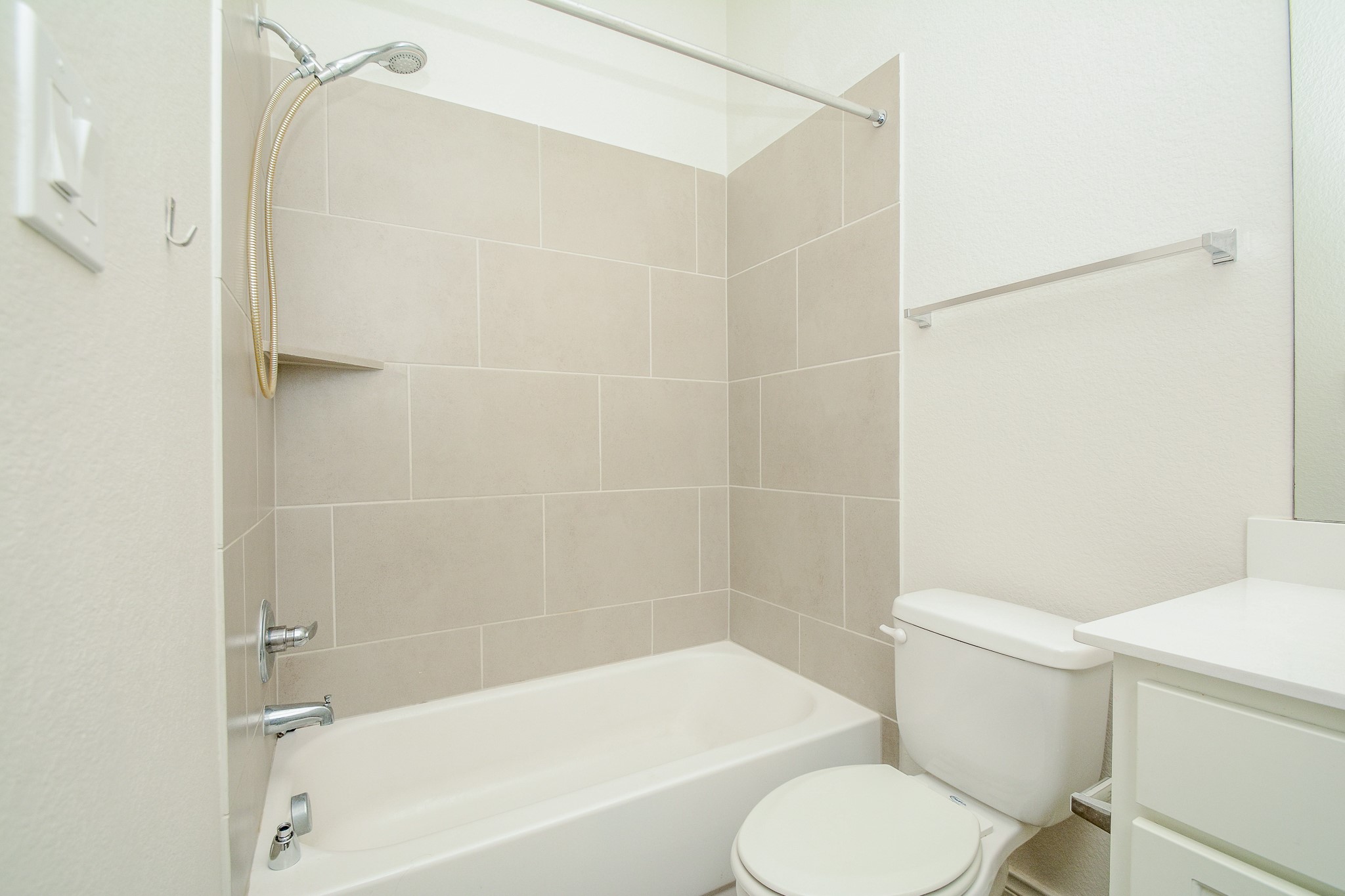 28127 Knight Peak Drive Spring, TX 77386 - Photo 37 of 42 a white toilet and tub sitting next to a bathroom sink