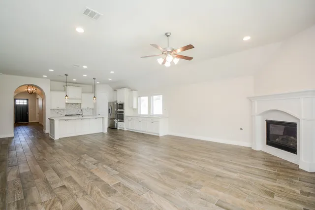 a view of a kitchen with a sink and a fireplace